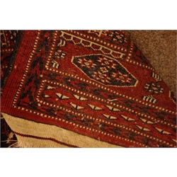  Persian Bokhara red ground rug, decorated with Guls, 255cm x 166cm  