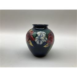 Three pieces of Moorcroft Pottery, comprising pot and cover of cylindrical form decorated in the Orchid pattern, H9cm, and two vases, the first example of ovoid form decorated in the Orchid pattern, the second decorated in the Clematis pattern, each with impressed marks beneath