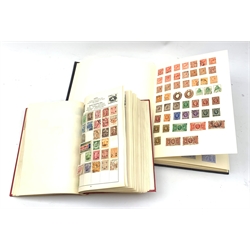 Two albums of world stamps, comprising The Cardinal Stamp Album, together with a further larger album, each containing Queen Victoria stamps.