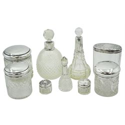 Group of silver mounted cut glass dressing table jars and bottles, of various size and form, to include one example of cylindrical form with plain cover hallmarked Barclay Brothers, Birmingham 1921, other examples with various hallmarks, dates ranging 1881 to 1935, approximate total weighable silver 2.12 ozt (66 grams)