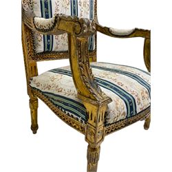 Late 20th century French design carved giltwood armchair, the cresting rail carved with scrolled foliage over foliate carved platform, upholstered in striped fabric decorated with trailing foliage and flower heads, acanthus carved arm terminals and upright supports, on turned and fluted supports 