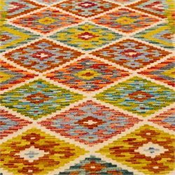 Turkish Anatolian flatweave kilim, ivory field decorated with rows of large stepped lozenge medallions enclosing stylized geometric motifs flanked by narrow geometric side panels, fringe ends 