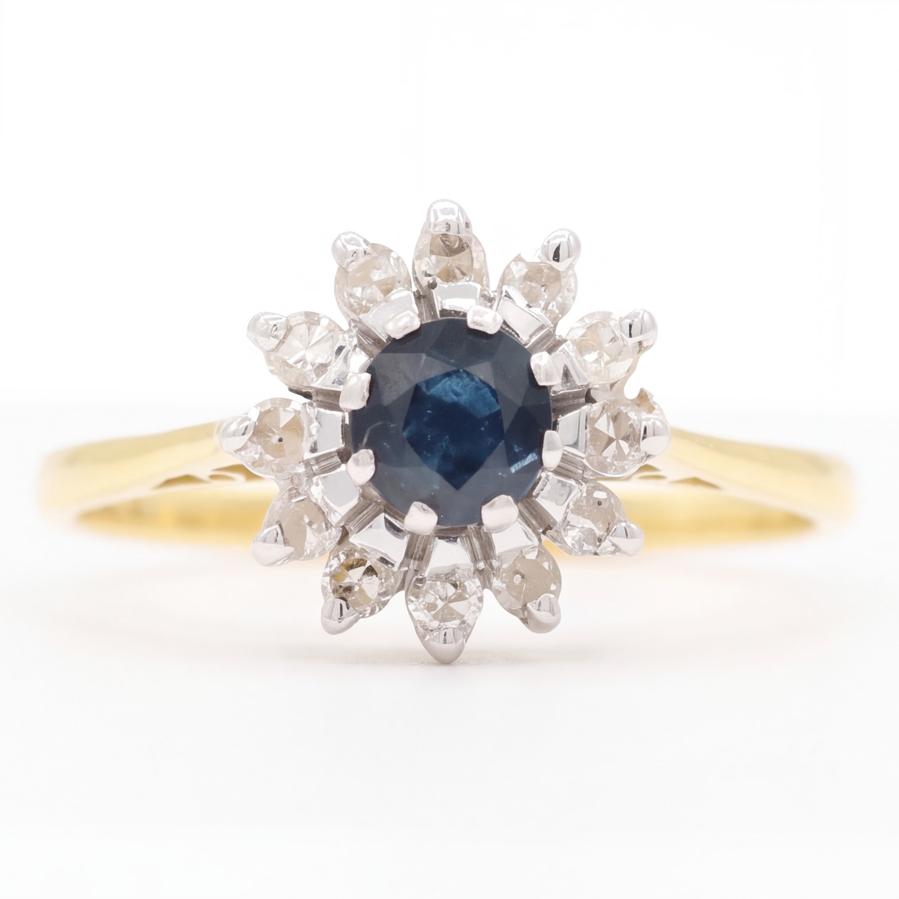 18ct gold sapphire and diamond cluster ring, single round cut sapphire surrounded by twelve single cut diamonds, Birmingham 1985