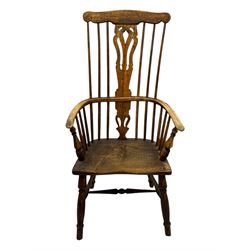 19th century provincial elm and beech Windsor armchair, shaped cresting rail over stick back with pierced and shaped splat, the dished seat on turned supports united by turned stretchers 