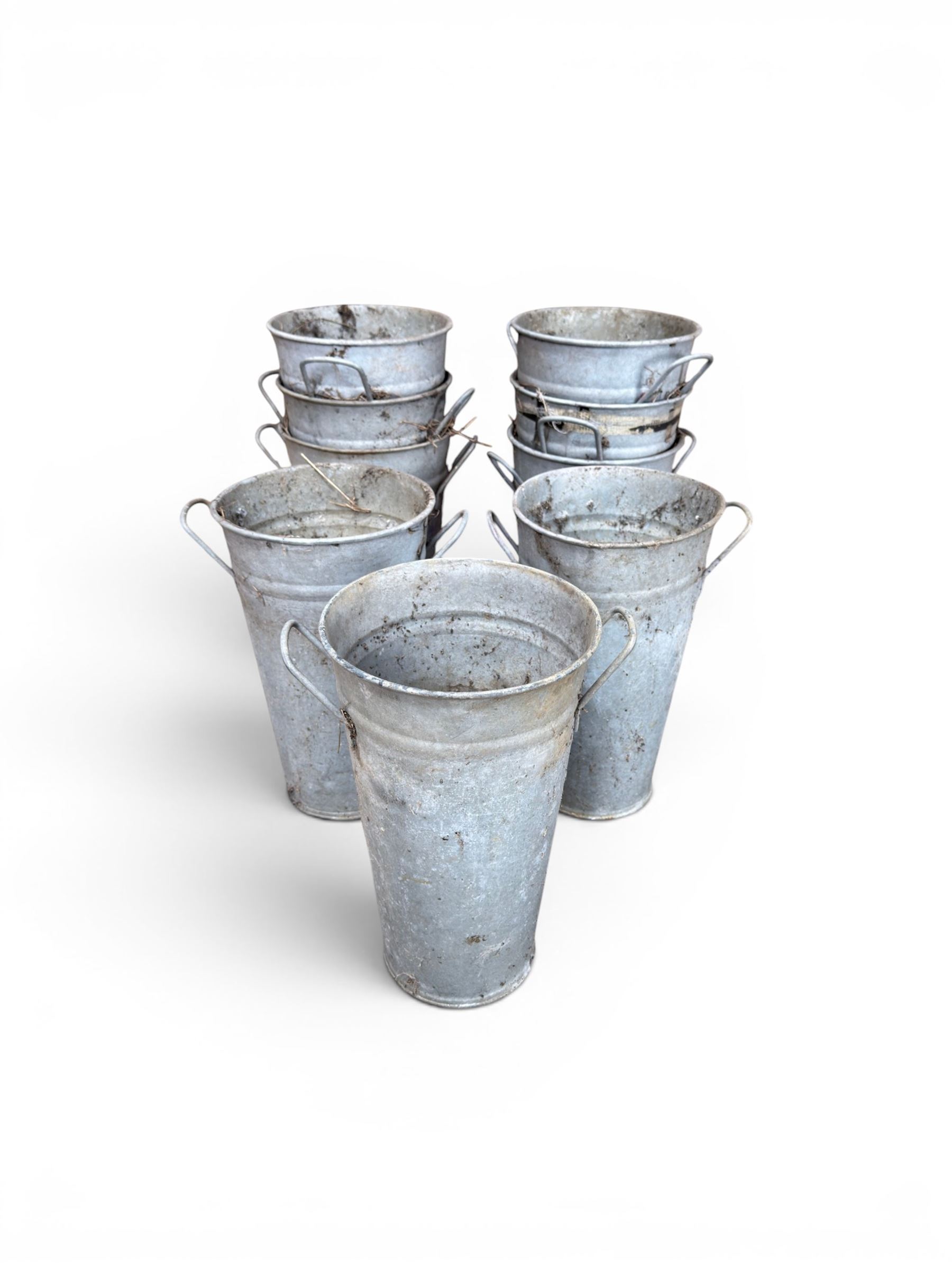 Nine galvanised flower buckets, tapering form with twin handles