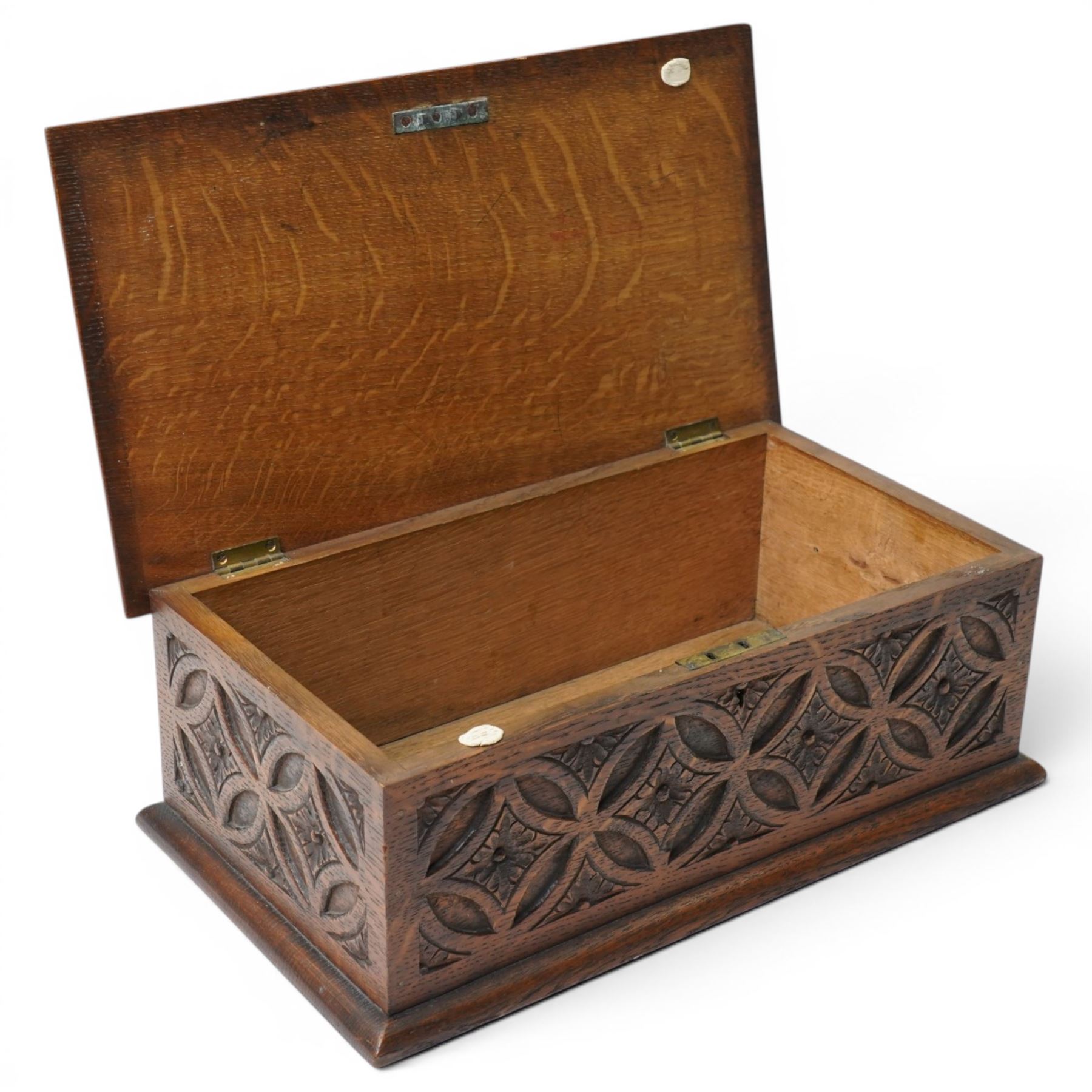 Elizabethan Revival style oak bible box, the central oval boss surrounded with carved strapwork and scrolled decoration, each side with repeating circular motif