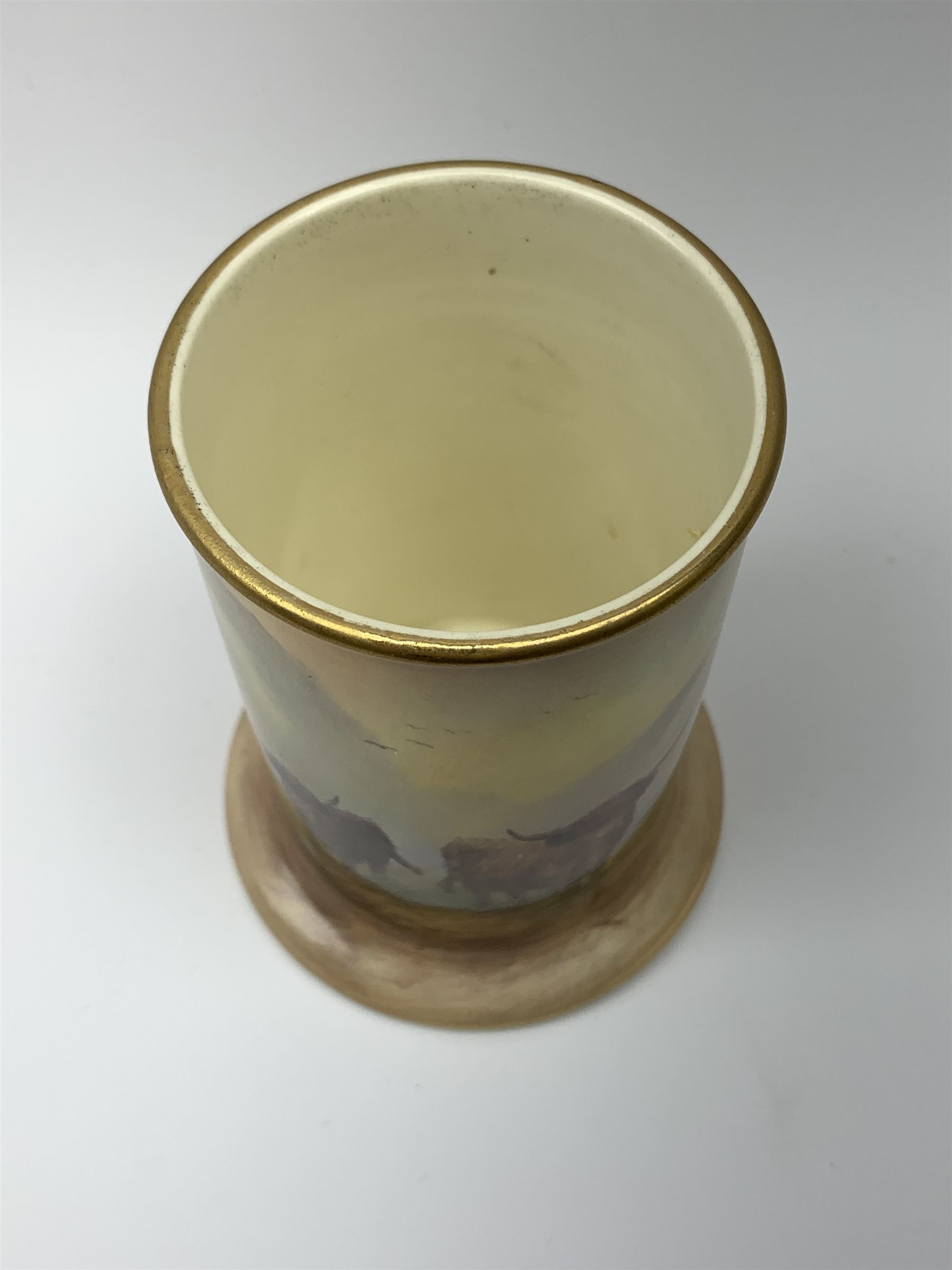 A Crown Devon Fieldings vase, of cylindrical form painted with a highland cattle scene and signed Cox, with printed marks beneath, H11.5cm