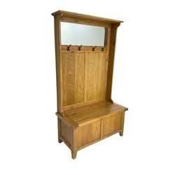 Oak mirror-back hall bench, projecting cornice, rectangular bevelled plate over four coat hooks, hinged box seat compartment with panelled front, on square tapering feet
