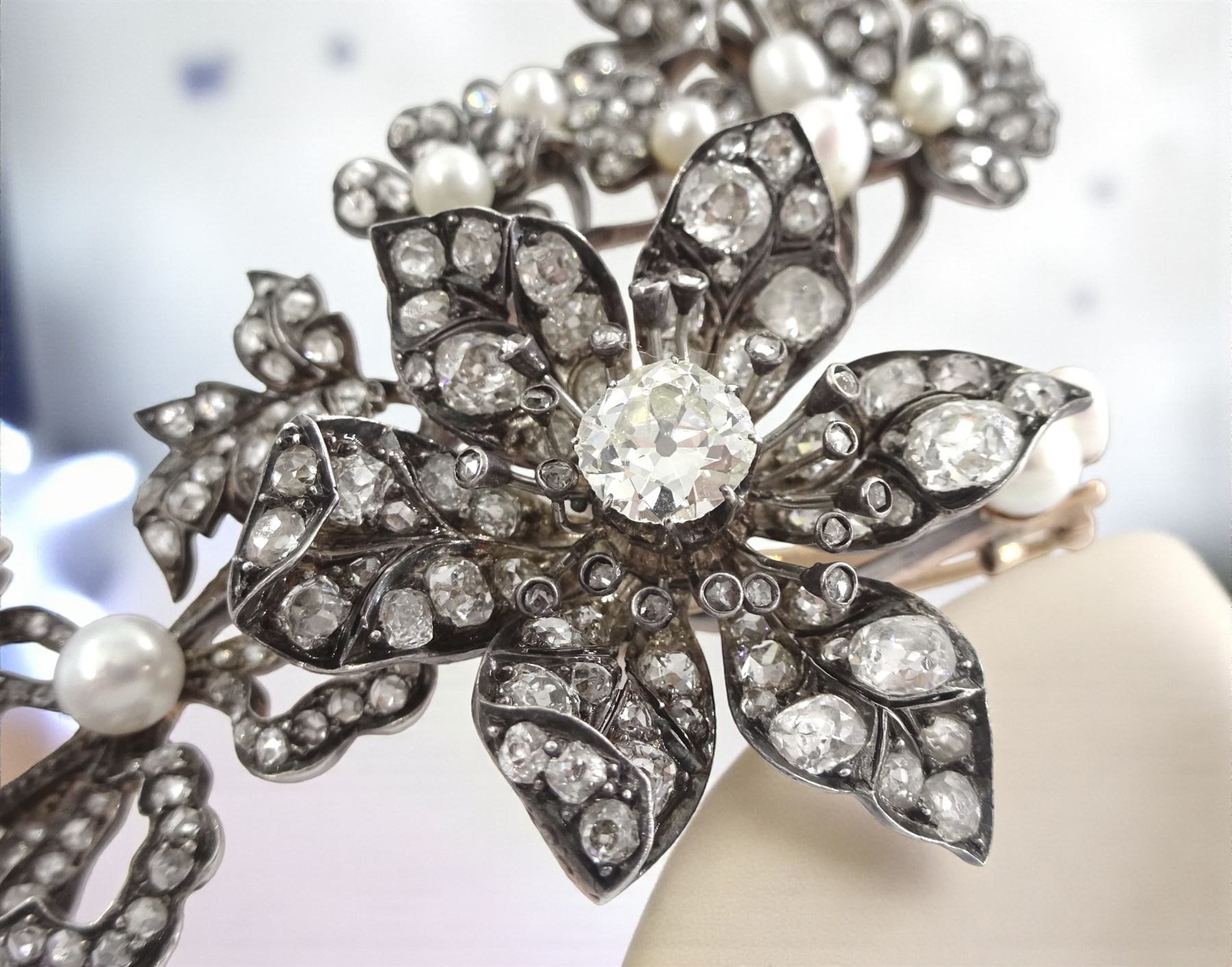 19th century gold and silver diamond and pearl en tremblant detachable brooch, the flower tremblant with a principal old cut diamond of approx 1.90 carat, the petals and stamen set with old cut and rose cut diamonds, total diamond weight approx 9.10 carat, to a foliate spray set set with further rose cut diamond and white / pink / cream pearls and ribbon tie