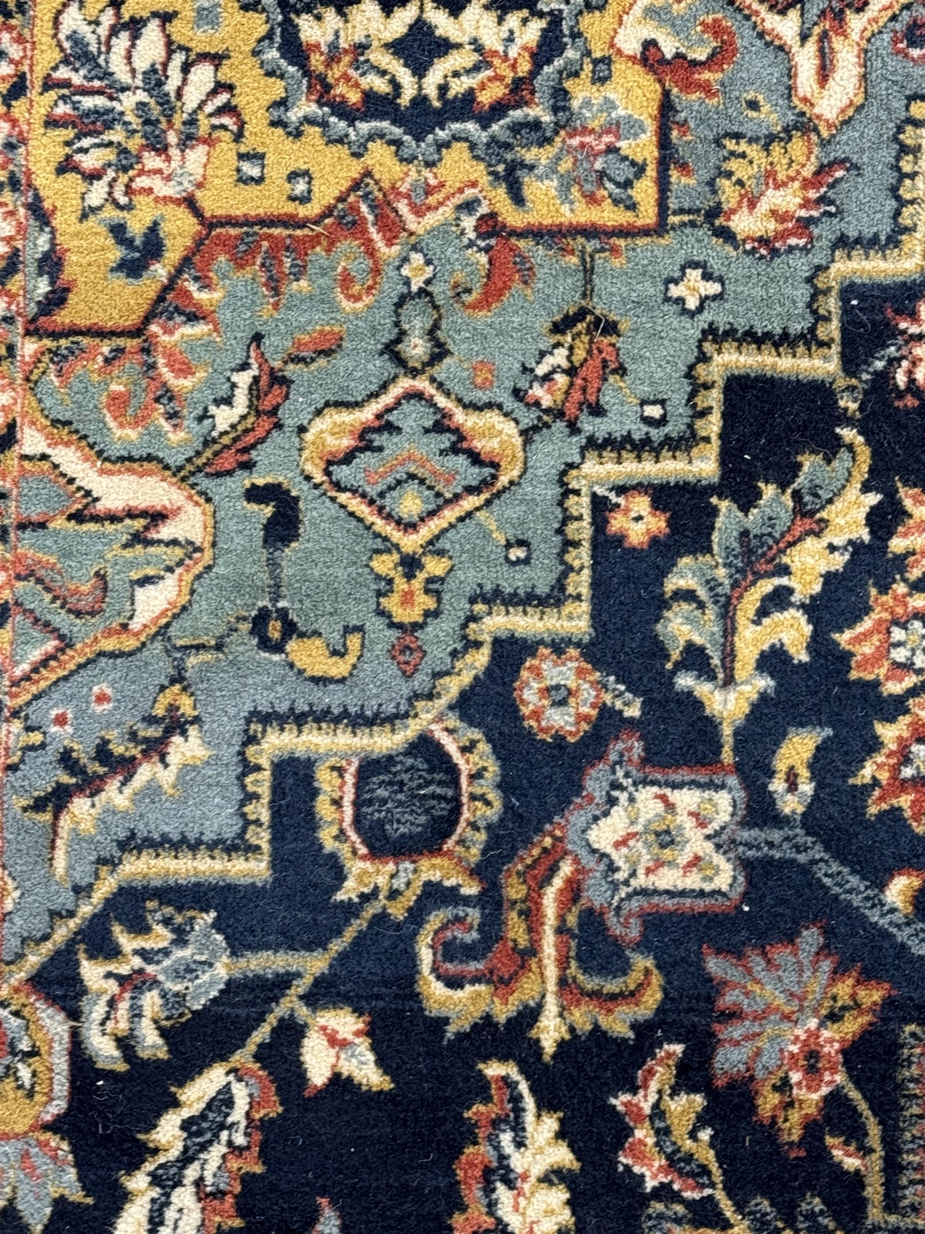 Belgian Sultan woollen ground rug, central navy field densely decorated with floral sprays and geometric patterns (192cm x 135cm); handwoven tribal terracotta ground rug (121cm x 71cm); Persian crimson ground runner, all over stylised floral and foliate motifs (266cm x 94cm)