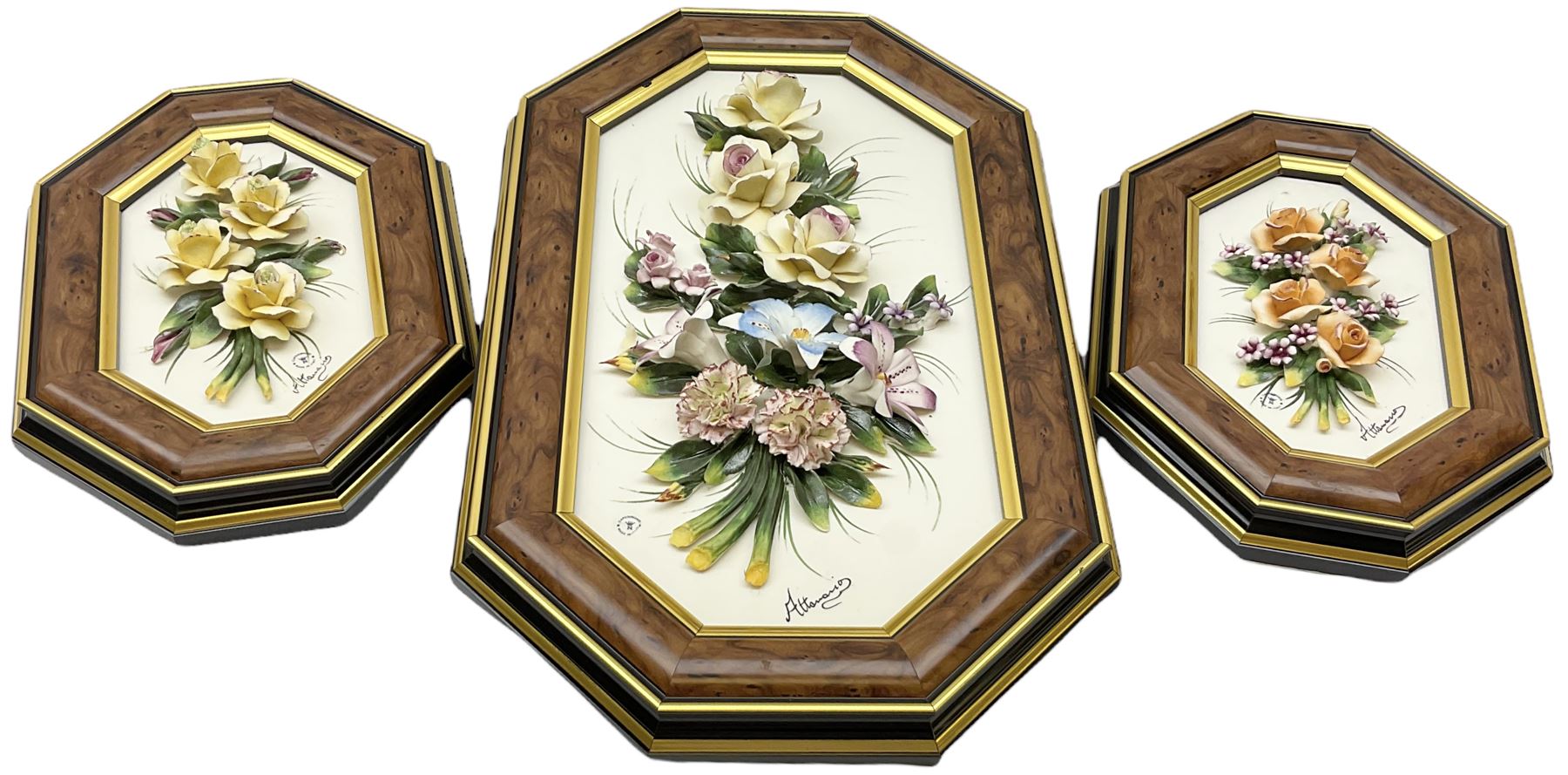 Set of three Capodimonte wall plaques, depicting floral decoration in octagonal frames with gilt edging, largest plaque H48, two small plaques H31cm.    