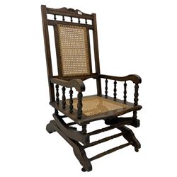 Early 20th century beech American rocking chair, with caned seat and back