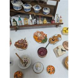 Victorian and later style dolls house kitchen furniture, including countertop, dresser displaying copper pots and blue and white ceramics, baking table, oven, three figures and a collection of food and baking accessories