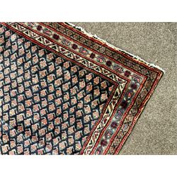 Persian Araak rug, blue ground field decorated with repeating Boteh motifs, three band border 