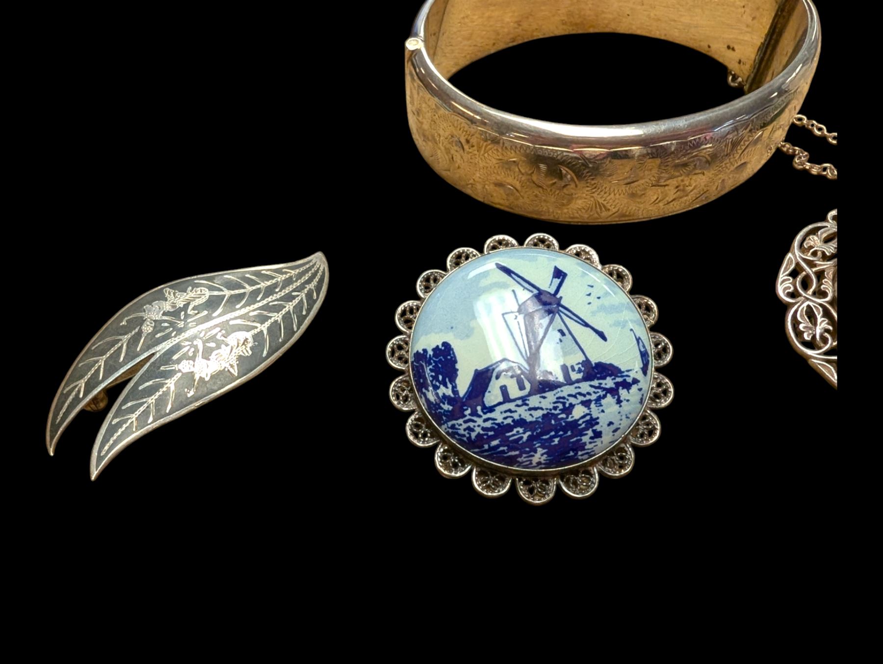 Silver bangle with four silver brooches