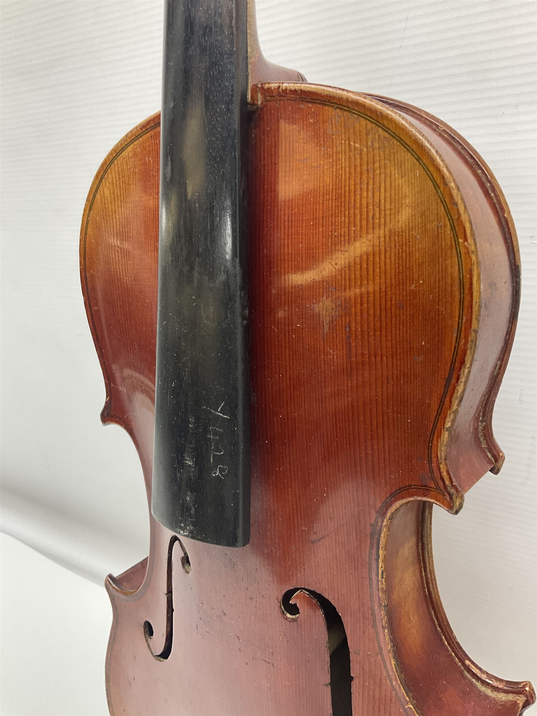 Late 19th century French three-quarter size 'Conservatory' violin with 34cm two-piece maple back and ribs and spruce top, the peg box inscribed 'Conservatory Violin Straduari', bears label 'Antonius Stradiuarius Cremonensis Faciebat Anno 1721' L55.5cm overall; in ebonised wooden 'coffin' case; and Saxony violin c1900 with 36cm two-piece maple back and ribs and spruce top; bears label 'Antonius Stradivarius Cremonensis Faciebat Anno 17**' L59cm overall; in carrying case (2)