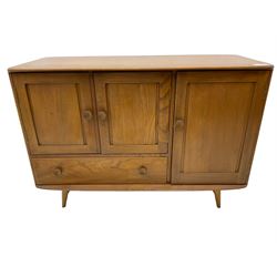 Ercol - elm and beech sideboard, fitted with cupboards and single drawer, enclosed by panelled doors, on splayed tapering feet
