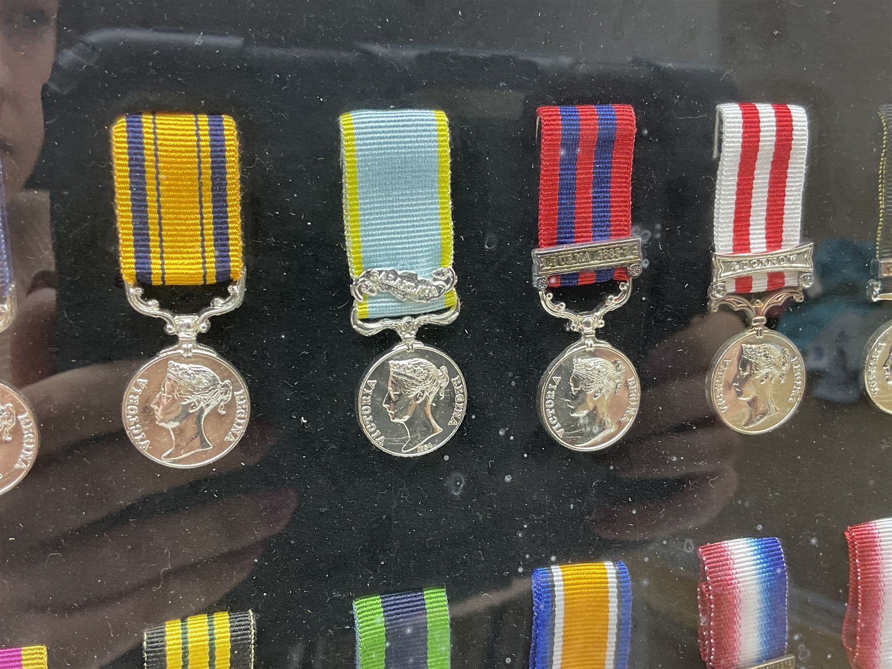 Limited edition large framed display board with sixty half-size copies of British Gallantry and Campaign Medals produced by Danbury Mint; all with ribbons and associated booklet