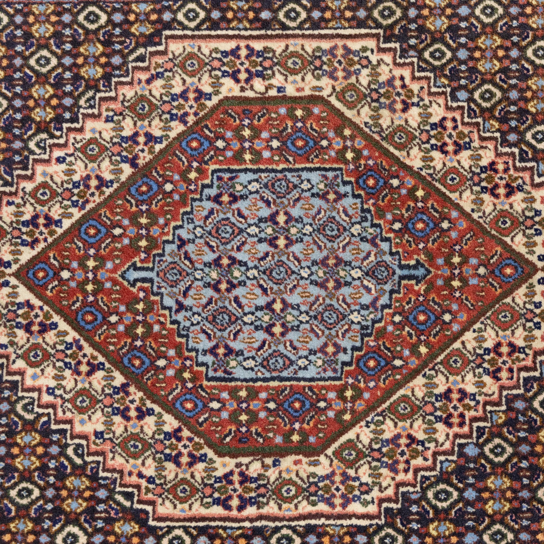 Persian Bijar prayer rug, dark brown ground with all-over Herati design surrounding a rust and pale blue central medallion, cream inner border and rust floral outer border