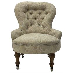 Victorian walnut framed nursing chair, upholstered in buttoned floral pattern fabric, on turned front feet 