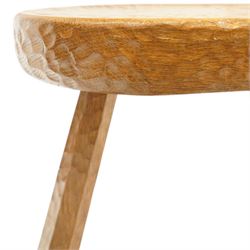 Squirrelman - rustic oak milking stool, adzed shaped top with exposed peg construction, on three tapering supports, with large carved squirrel signature, by Wilf Hutchinson, Husthwaite