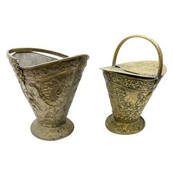 19th Century brass embossed coal scuttle with double-sided hinged lid, raised on a spreading foot and another similar with swing handle decorated with winged dragons, max H44cm