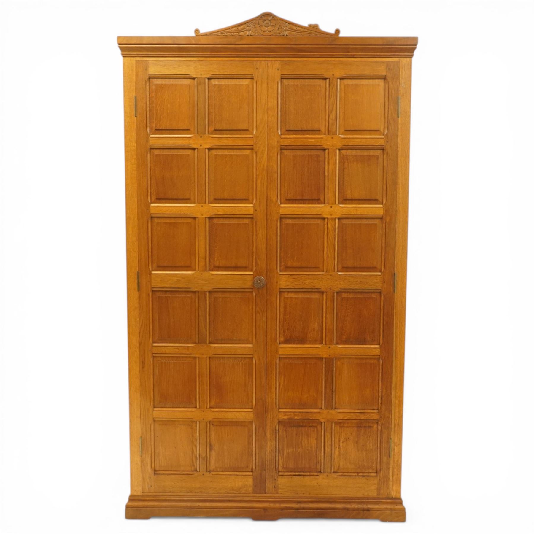 Beaverman - Yorkshire oak panelled double wardrobe, with carved pediment, panelled doors and sides, with internal top shelf above a single hanging rail, with carved beaver signature, by Colin Almack of Sutton near Thirsk