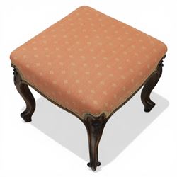 19th century mahogany framed footstool on floral carved cabriole supports upholstered in coral fabric