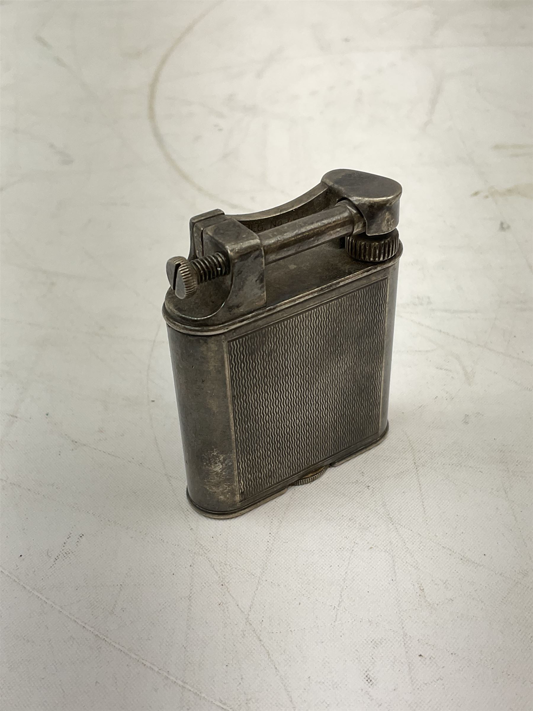 Dunhill silver plated lift-arm lighter, of rectangular form with engine turned decoration, signed Dunhill, base impressed Pat. No. 390107, H5cm