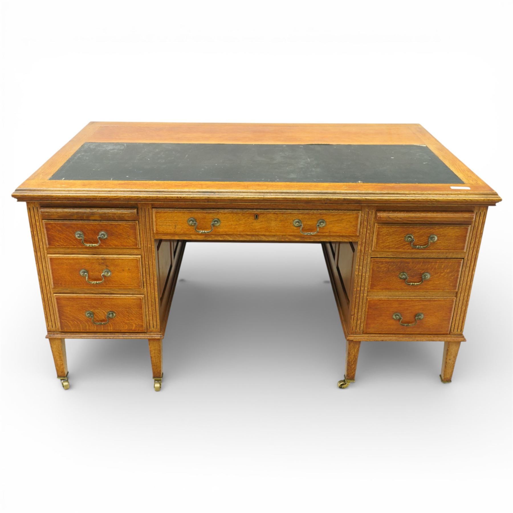20th century oak kneehole desk, rectangular black leather inset top, above a single frieze drawer, flanked by two pedestals with slides and drawers, panelled sides and back 