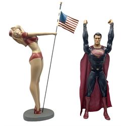Composite Superman with cape, together with a composite female statue holding the American flag, tallest example H103cm
