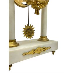French - Late 19th century 8-day white marble and gilt metal portico clock garniture, the clock surmounted by an urn and raised on a pair of cylindrical pillars above a rectangular plinth base, white enamel dial with Arabic numerals and floral garlands, twin train countwheel striking movement, striking the hours and half hours on a bell, with a sunburst pendulum and gilt Louis XVI hands, garniture with matching twin light candelabra. With Key.   Candelabra H 30cm.