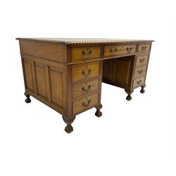 Mid-20th century walnut twin pedestal desk, dark green leather inset top with carved gardoon edge, fitted with nine drawers, panelled pedestals on ball and claw cabriole feet 