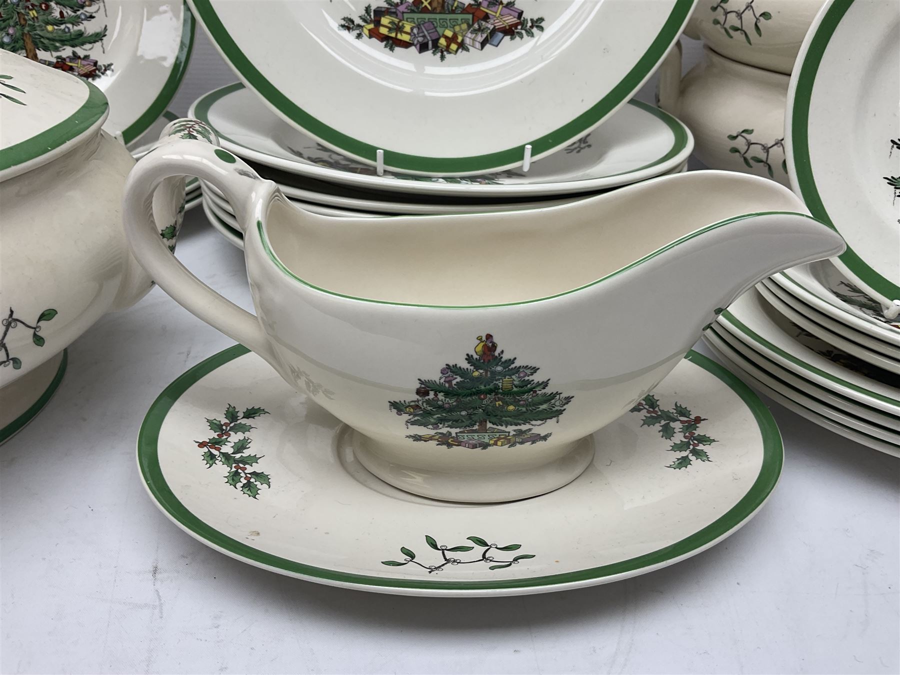 Collection of Spode Christmas Tree pattern part dinner service, comprising three covered tureens, eight dinner plates, eight side plates, eight dessert plates, sauce boat and saucer and serving platter (30)