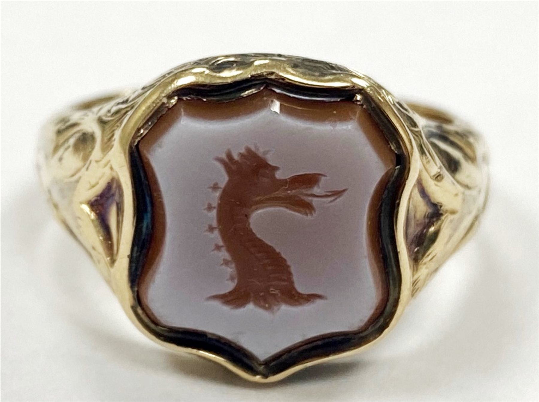 Victorian 15ct gold bloodstone lion intaglio, shield shaped signet ring and a 9ct gold agate dragon intaglio ring