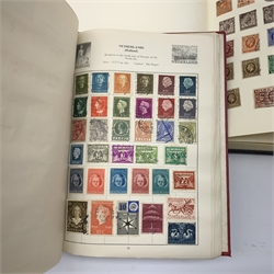 Two albums of world stamps, comprising The Cardinal Stamp Album, together with a further larger album, each containing Queen Victoria stamps.