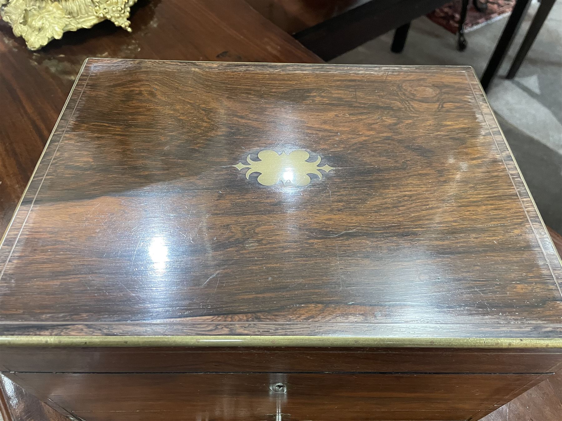  Victorian brass inlaid rosewood dressing table box, retailed by F.L. Hausburg, Liverpool, the lid centred by a brass cartouche, opening to reveal letter store to lid underside, above a fitted interior, with ten mounted cut glass jars, bottles and manicure set, within lift out leather trays, above jewellery drawer, with key, H17cm D24cm