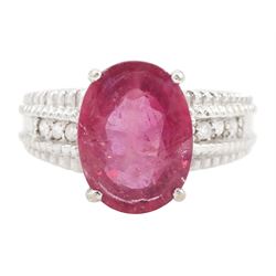 18ct white gold ruby and diamond ring, single oval cut ruby of approx 5.05 carat, with thr...