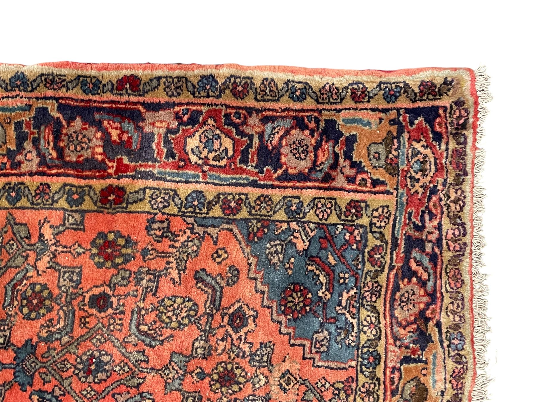 Persian Zanjan pale red ground rug, lozenge medallion and field decorated with floral Herati motifs, the border decorated with stylised plant motifs and trailing branches, floral pattern guard stripes