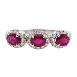White gold three stone oval ruby and round brilliant cut diamond cluster ring, hallmarked