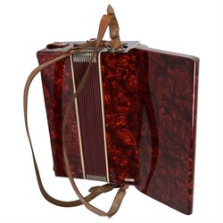 World master piano accordion with  14 fold bellows, two octave keyboard and 32 buttons. With a hard carrying case.