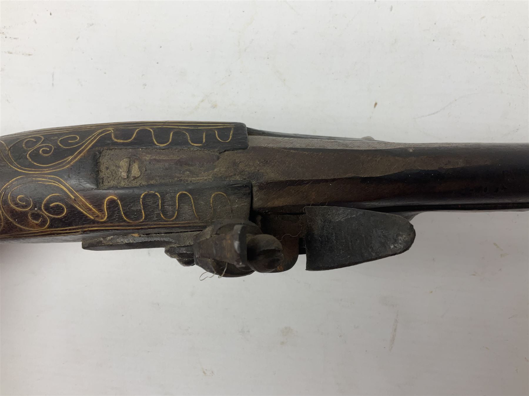 Reproduction flintlock pistol, the full walnut stock with brass filigree inlay and mounts and skull crusher butt L46cm; no visible proof marks FIREARMS CERTIFICATE REQUIRED OR RFD