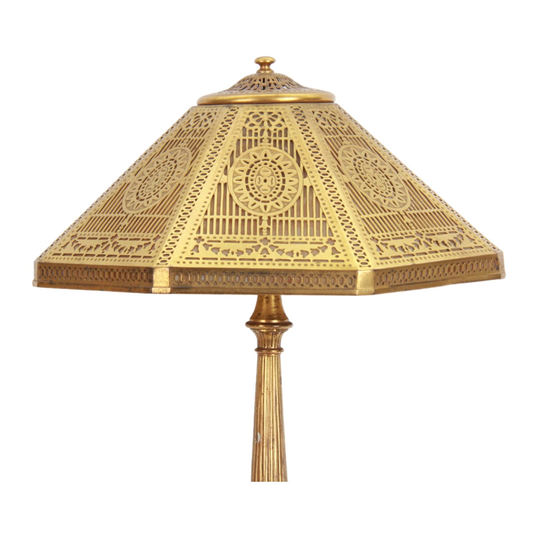 In the manner of Tiffany & Co, early 20th century gilt bronze Adam pattern table lamp, circa 1910, the circular spreading base decorated with flower heads and beaded bands, stiff leaves and husks, leading to a reeded column detailed with stiff leaves and swags, supporting a pierced octagonal shade, with original fittings, stamped beneath Tiffany Studios New York 539, overall H44.5cm


