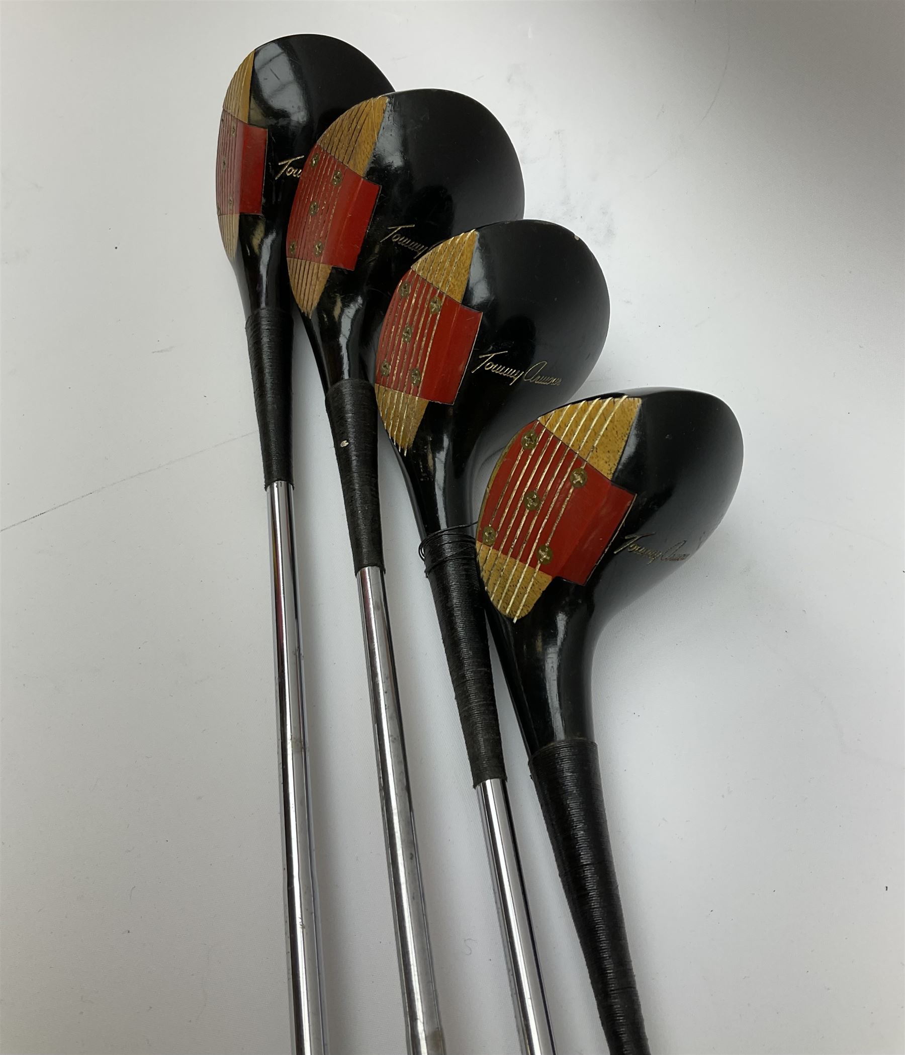 Golf - three early 20th century hickory shafted irons marked R. Simpson, Harrods Ltd etc; child's wooden shafted putter; two transitional wood grain steel shafted irons, one marked Tom Morris; and set of four Macgregor Tommy Armour woods (10)