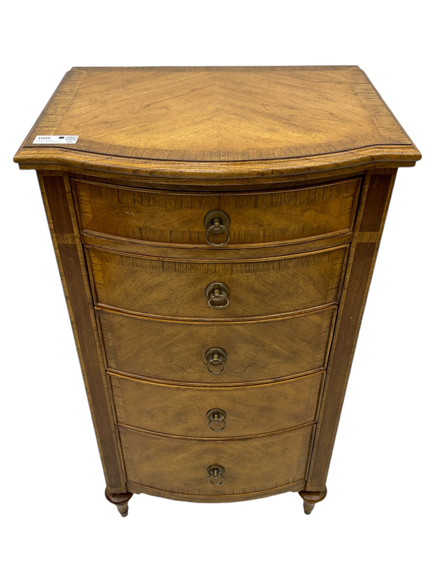Frank Hudson - mid-20th century Mindi ash and burr walnut bow-fronted lingerie chest, crossbanded hinged top concealing vanity mirror, over five graduated cockbeaded drawers, raised on turned supports