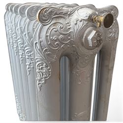 French ornate cast iron column radiator of Rococo Revival design, each section cast with scrolling foliate decoration with rocaille and cartouche motifs, with brass valve and integral bracket feet, in painted silvered finish