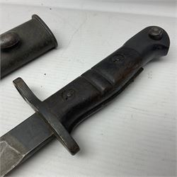 WW1 British pattern 1913 bayonet with 43cm fullered steel blade; various markings to ricasso; in metal mounted leather covered scabbard L57cm overall