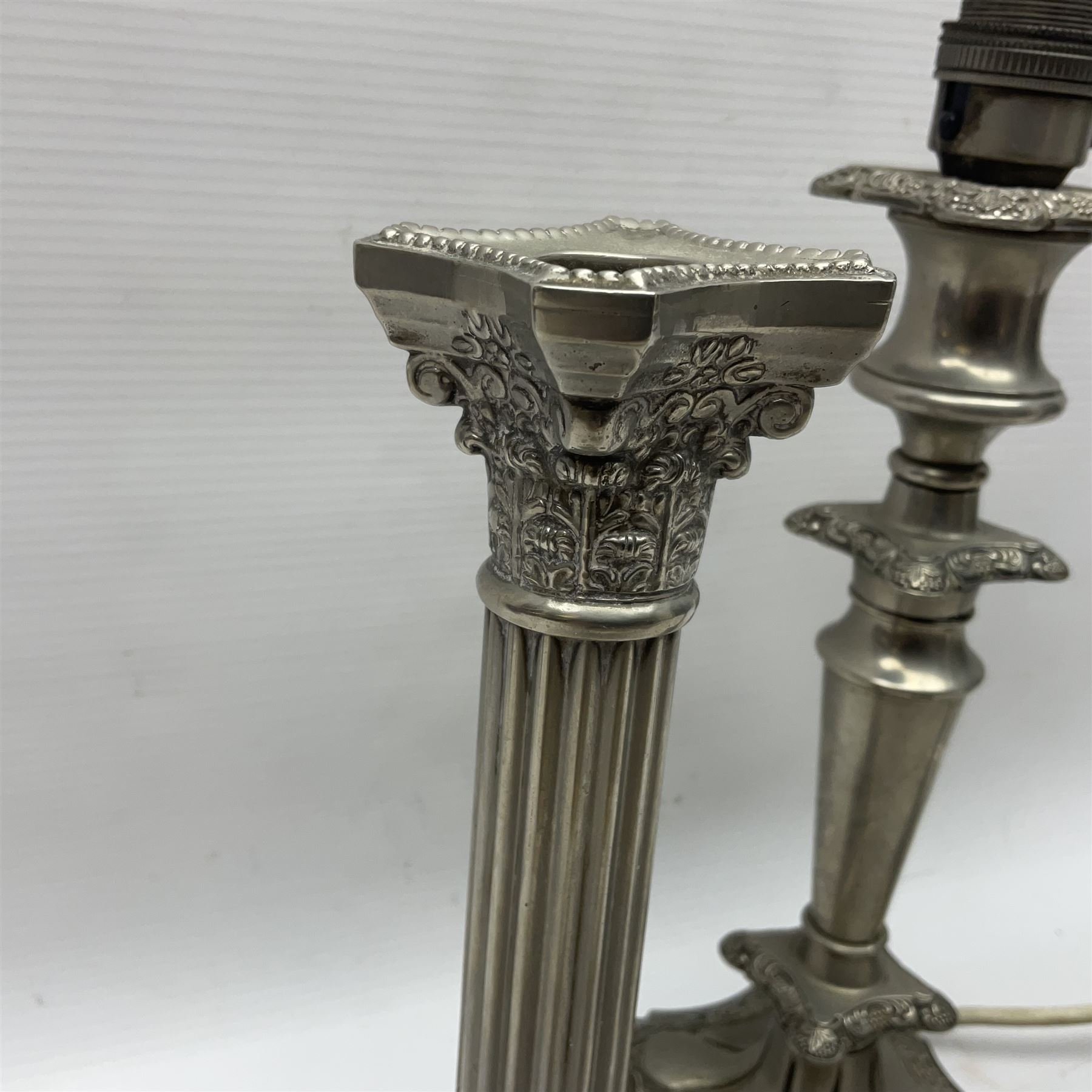 Pair of Corinthian column candlesticks, and a silver plated lamp, candlesticks H26cm