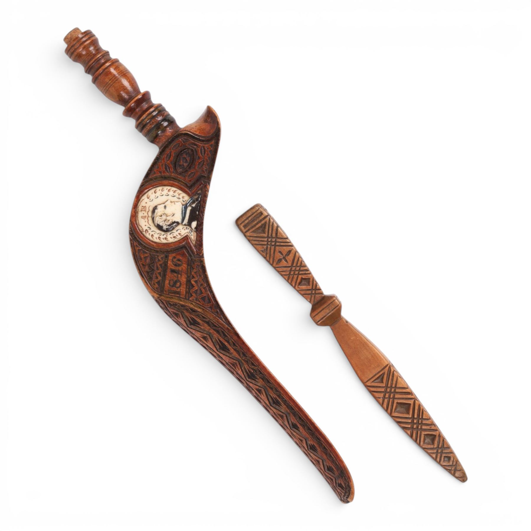 19th Century fruitwood goose-wing knitting sheath, decorated with geometric patterns, with a inset bone bust initialled A.B, together with a carved peg knitting stick, sheath L26cm
