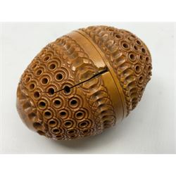 Three 19th century coquilla nut pomanders or flea catchers, each of egg shaped form with carved and pierced decoration and screw threaded join, largest example 6cm